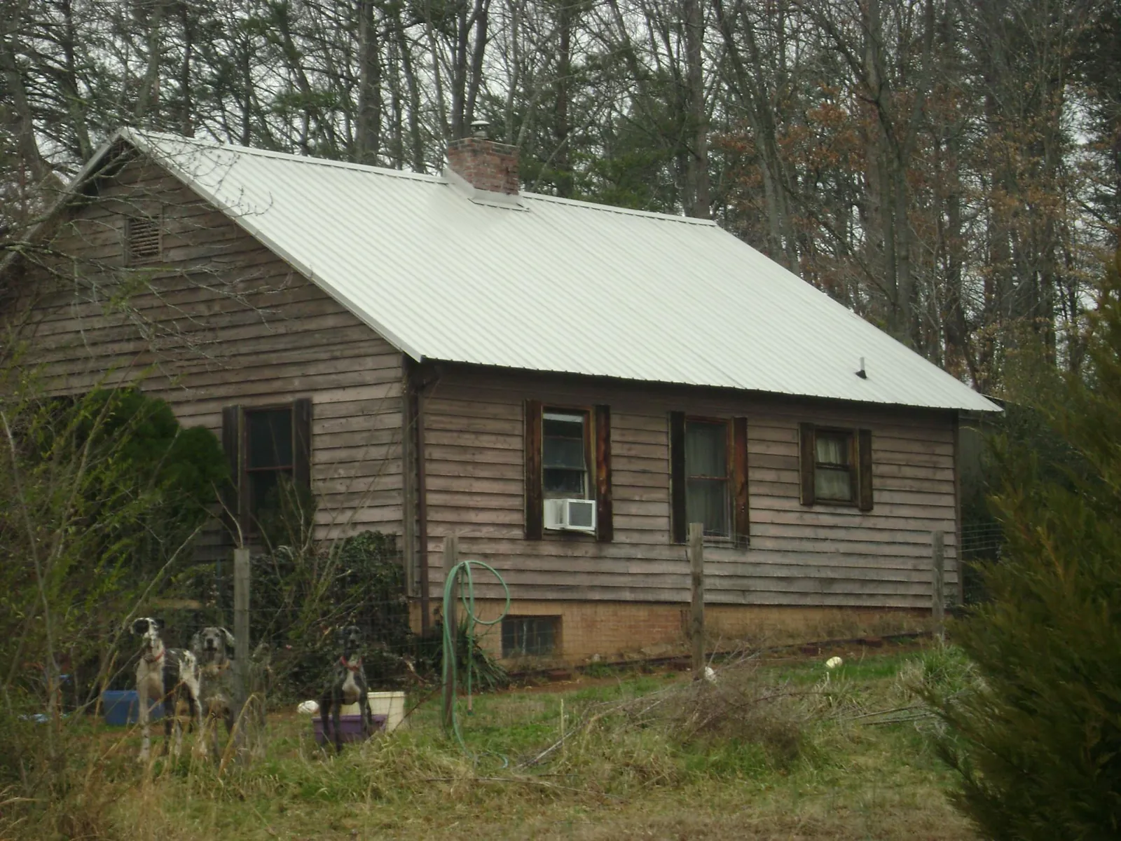 White metal roof on an old wood sided farmhouse, from a Asphalt Shingle Roof Repair job in Dublin